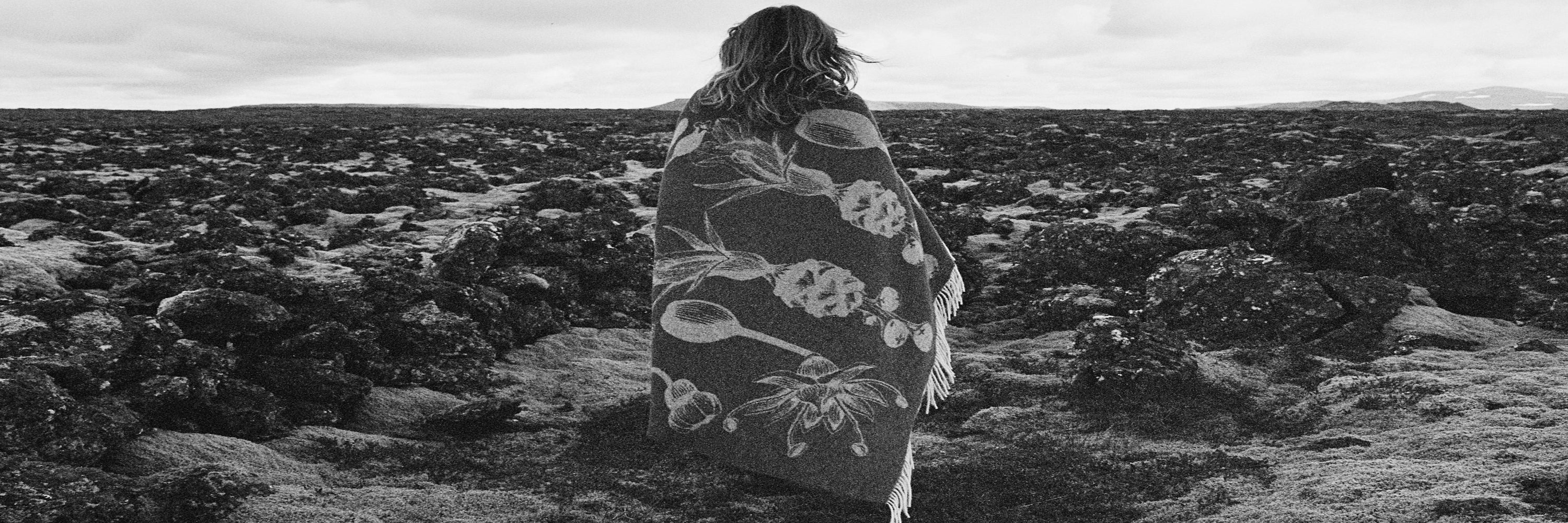 Fischersun Blanket wrapped around a woman standing on Icelandic Landscape